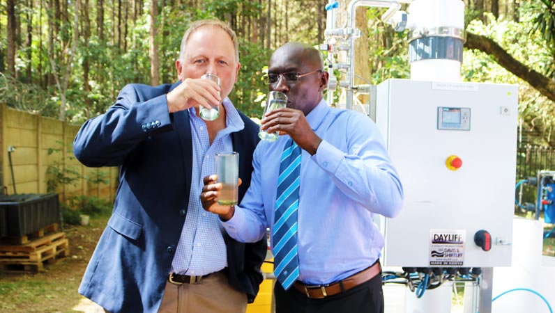 Dayliff DOW Ultrafiltration Event David Gatende having clean Water for drinking from Dayliff DOW Ultrafiltration Event