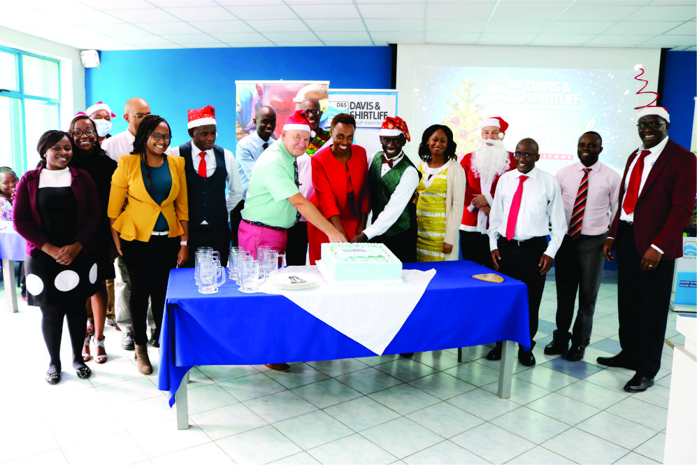 Chairman Alec Davis and David Gatende cutting the christmas cake with other members of staff Chairman Alec Davis and David Gatende cutting the christmas cake with other members of staff